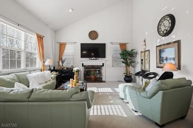 a living room with furniture a large window and a flat screen tv