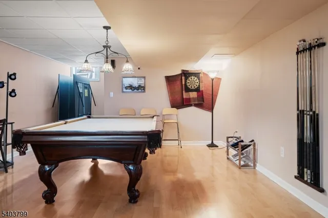 a room with pool table and windows