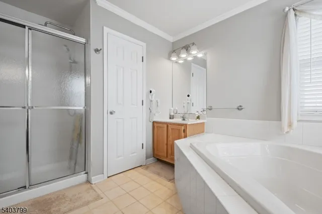 a spacious bathroom with a tub shower and sink