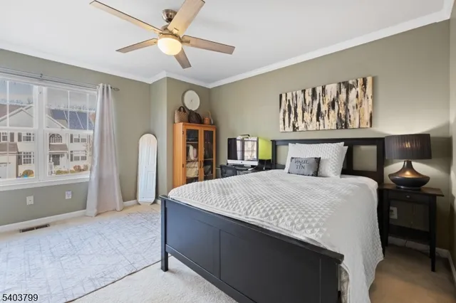 a spacious bedroom with a large bed and a chandelier