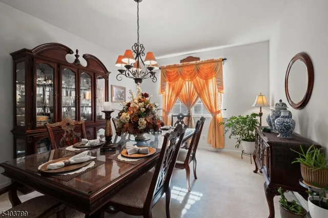 a view of a dining room with furniture and chandelier