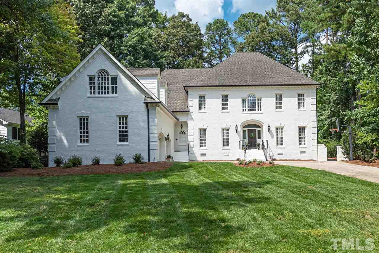7016 North Ridge Drive Raleigh, NC 27615 - Photo 1 of 30 a front view of a house with a yard and trees