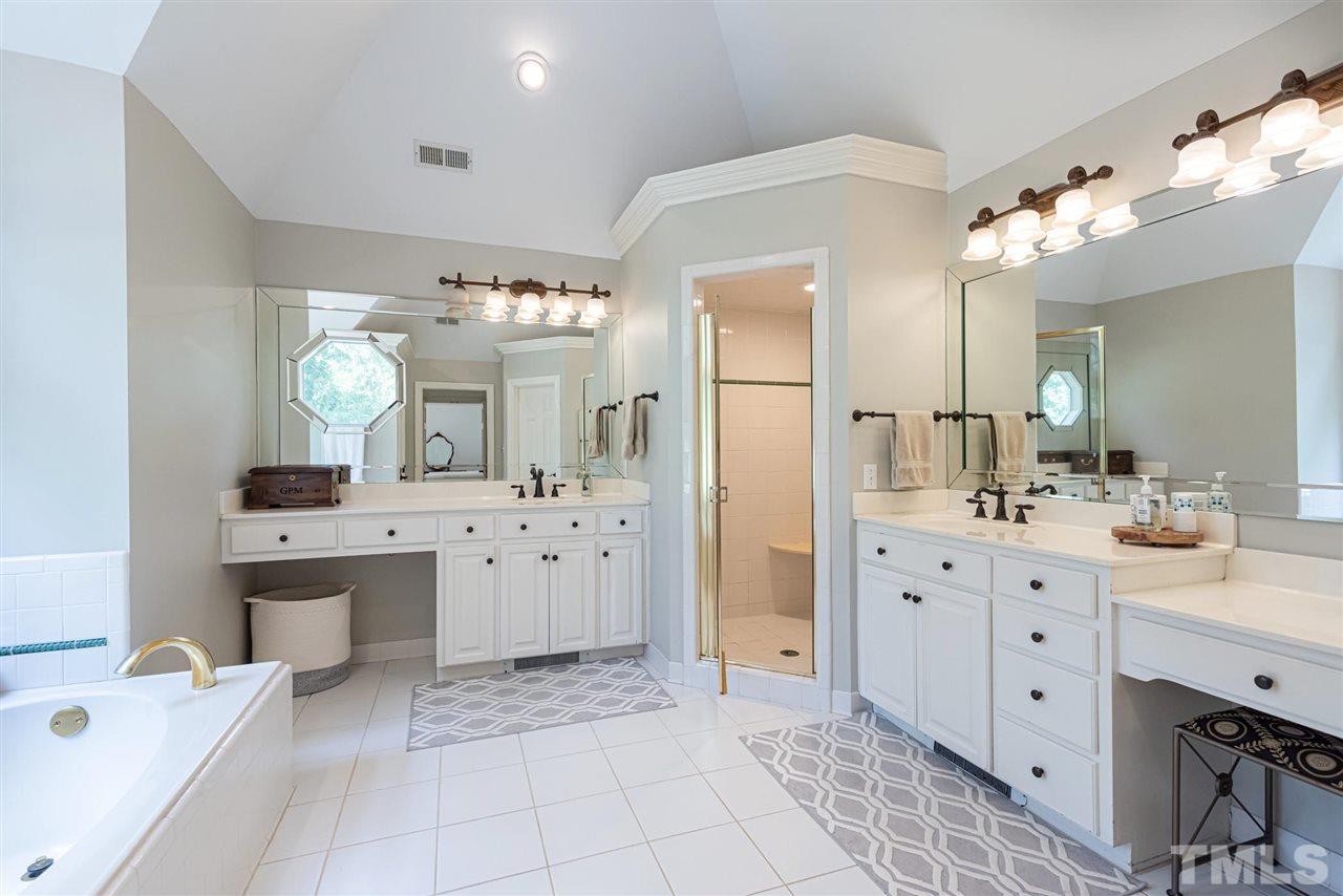 7016 North Ridge Drive Raleigh, NC 27615 - Photo 15 of 30 a spacious bathroom with a double vanity sink mirror and bathtub