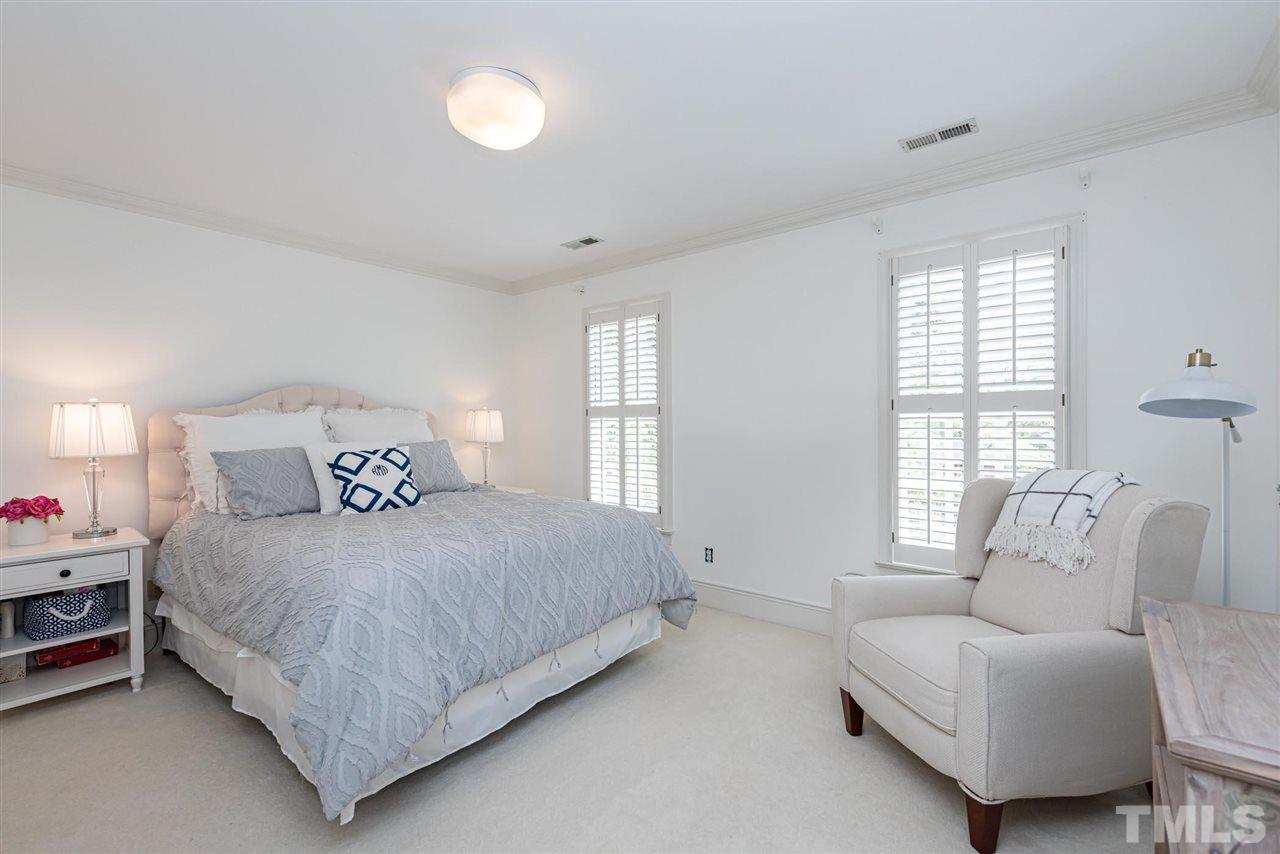 7016 North Ridge Drive Raleigh, NC 27615 - Photo 17 of 30 a bedroom with a bed and a couch