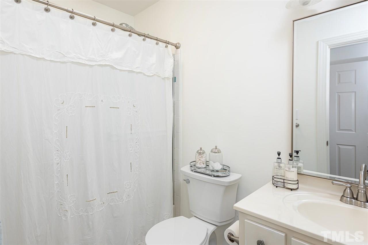 7016 North Ridge Drive Raleigh, NC 27615 - Photo 18 of 30 a bathroom with a sink toilet and shower