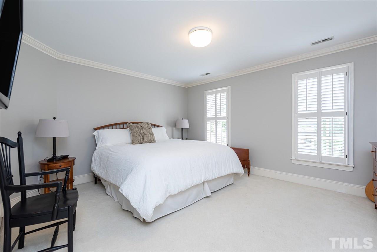 7016 North Ridge Drive Raleigh, NC 27615 - Photo 19 of 30 a bedroom with a bed and window