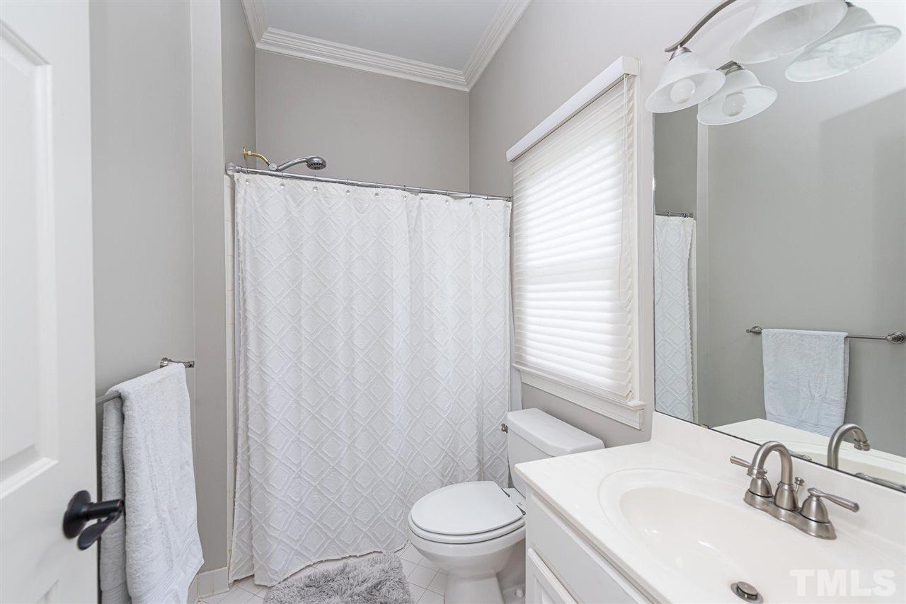 7016 North Ridge Drive Raleigh, NC 27615 - Photo 22 of 30 a bathroom with a sink toilet and shower