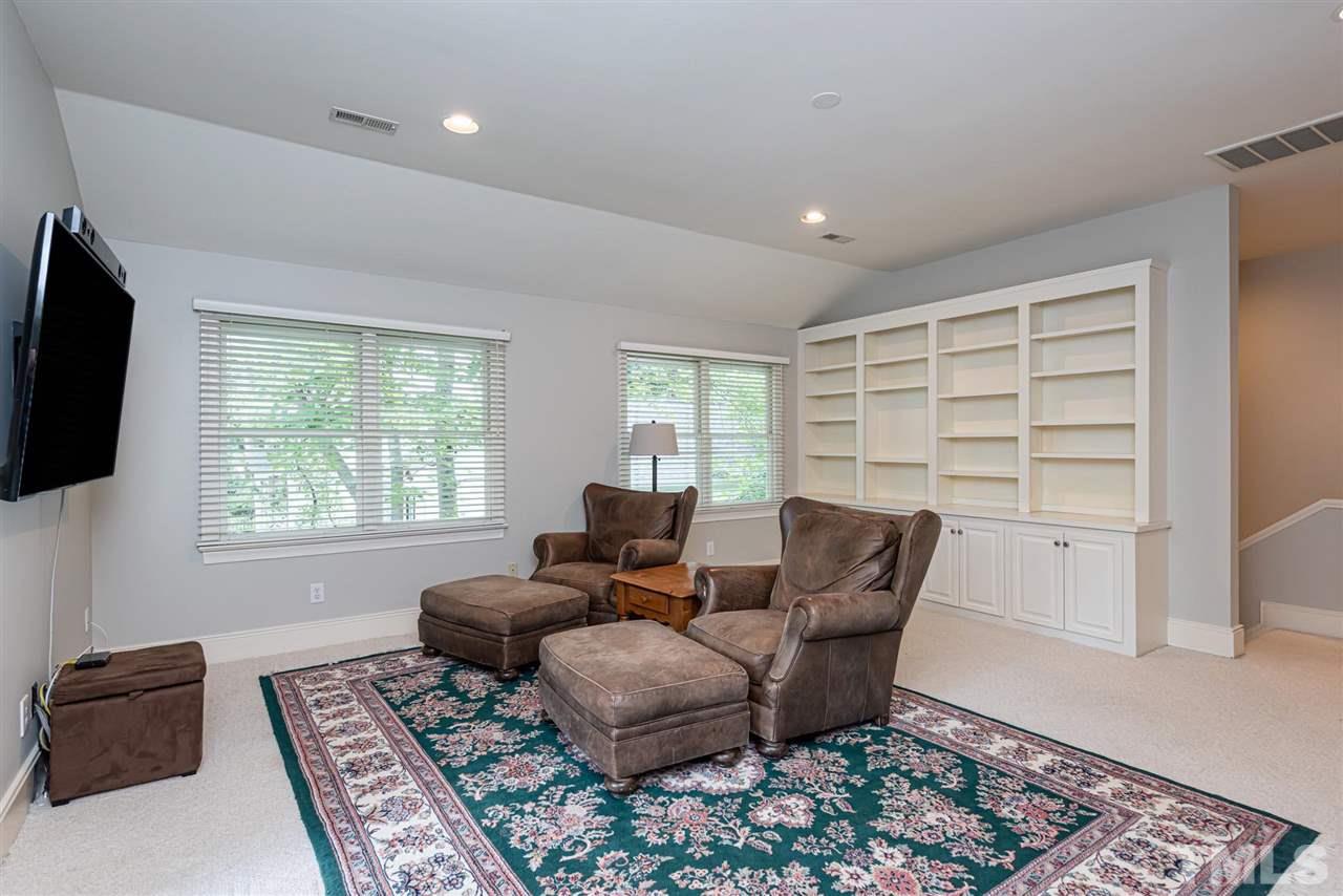 7016 North Ridge Drive Raleigh, NC 27615 - Photo 24 of 30 a living room with furniture and a flat screen tv