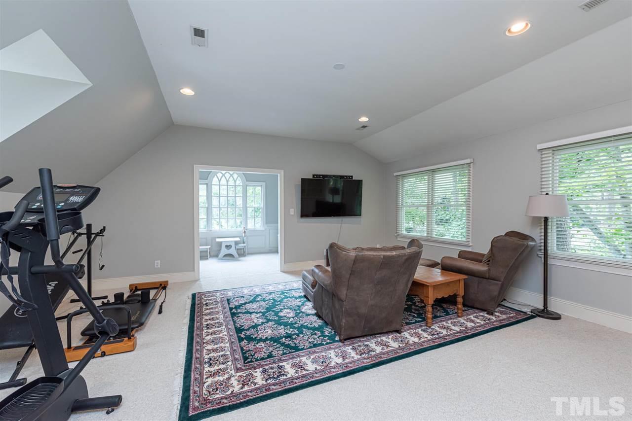 7016 North Ridge Drive Raleigh, NC 27615 - Photo 25 of 30 a living room with furniture windows and a flat screen tv