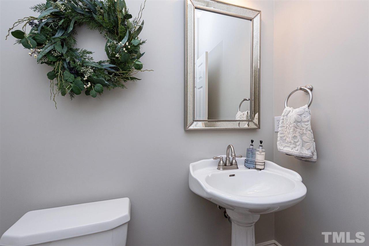7016 North Ridge Drive Raleigh, NC 27615 - Photo 27 of 30 a bathroom with a sink toilet and mirror
