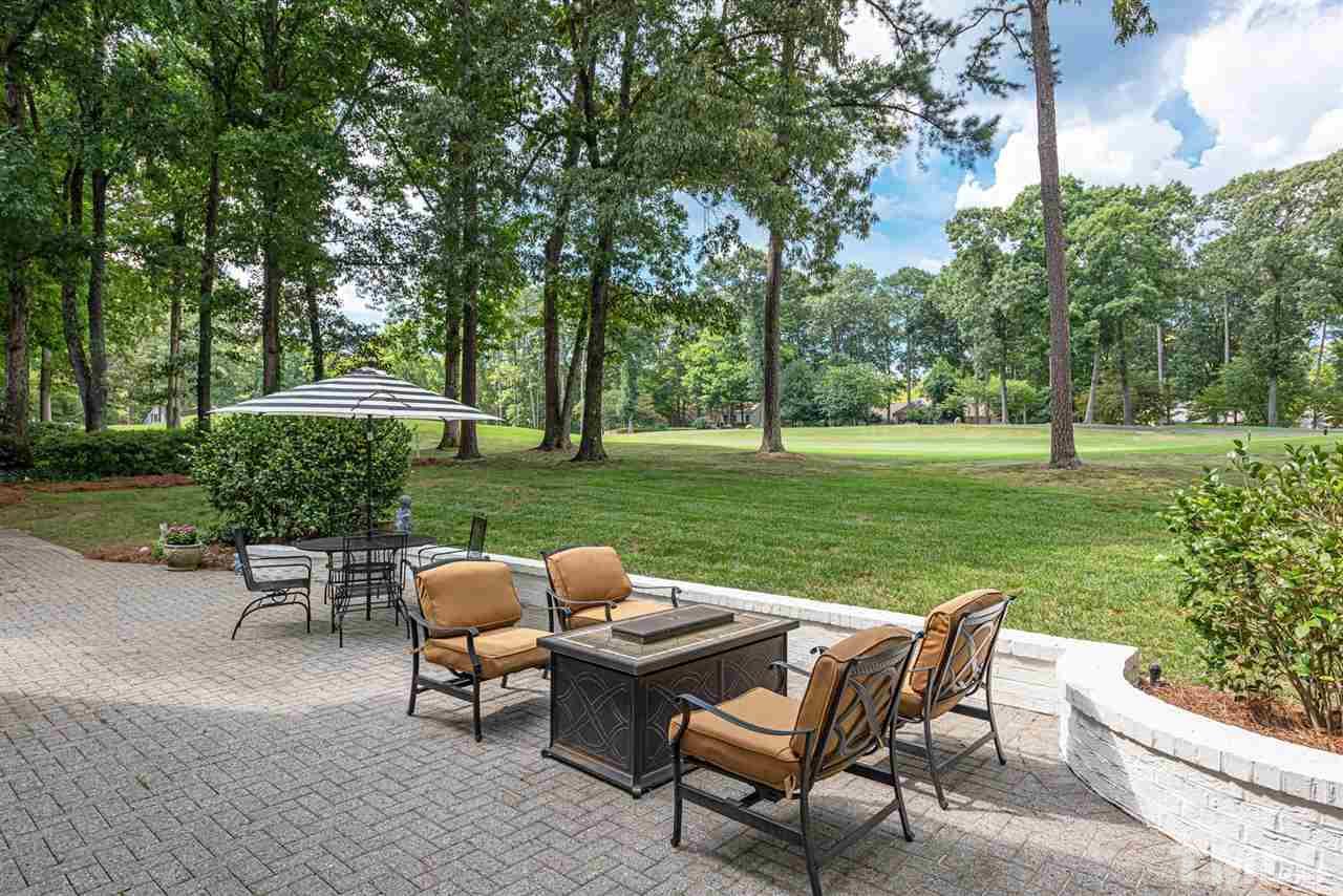 7016 North Ridge Drive Raleigh, NC 27615 - Photo 28 of 30 a view of a table and chairs on the deck