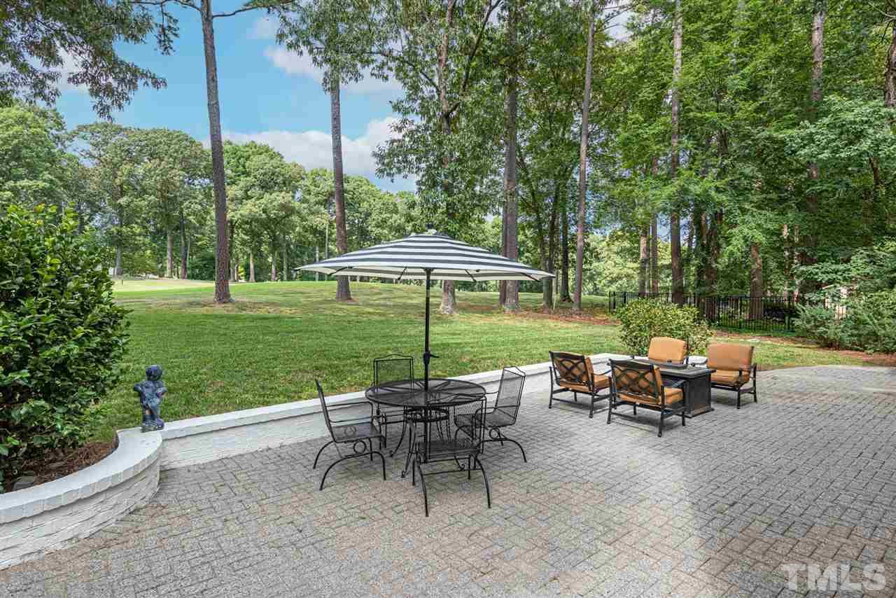 7016 North Ridge Drive Raleigh, NC 27615 - Photo 29 of 30 a view of a table and chairs in backyard of the house