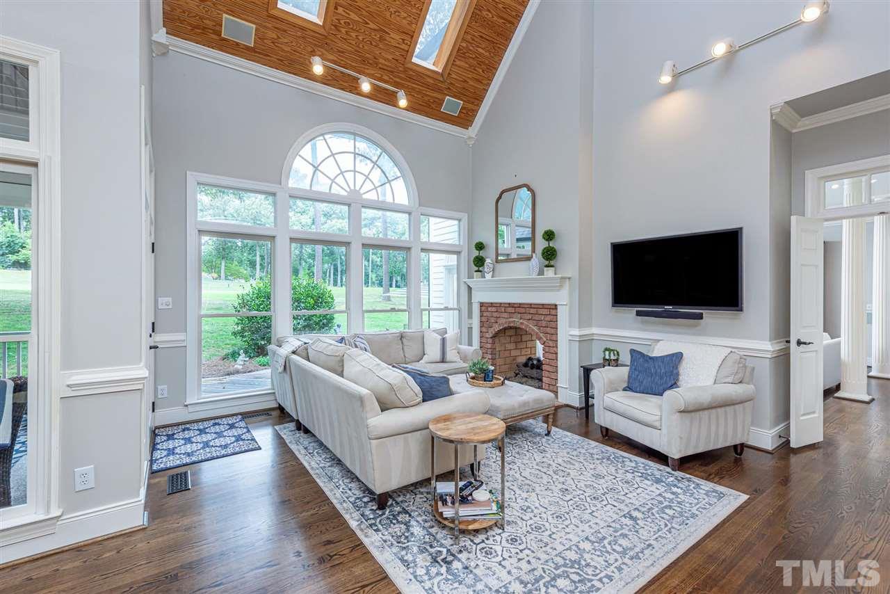 7016 North Ridge Drive Raleigh, NC 27615 - Photo 10 of 30 a living room with furniture a flat screen tv and a fireplace