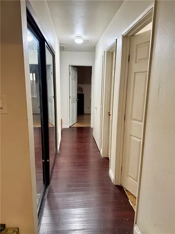 a view of a hallway with wooden floor