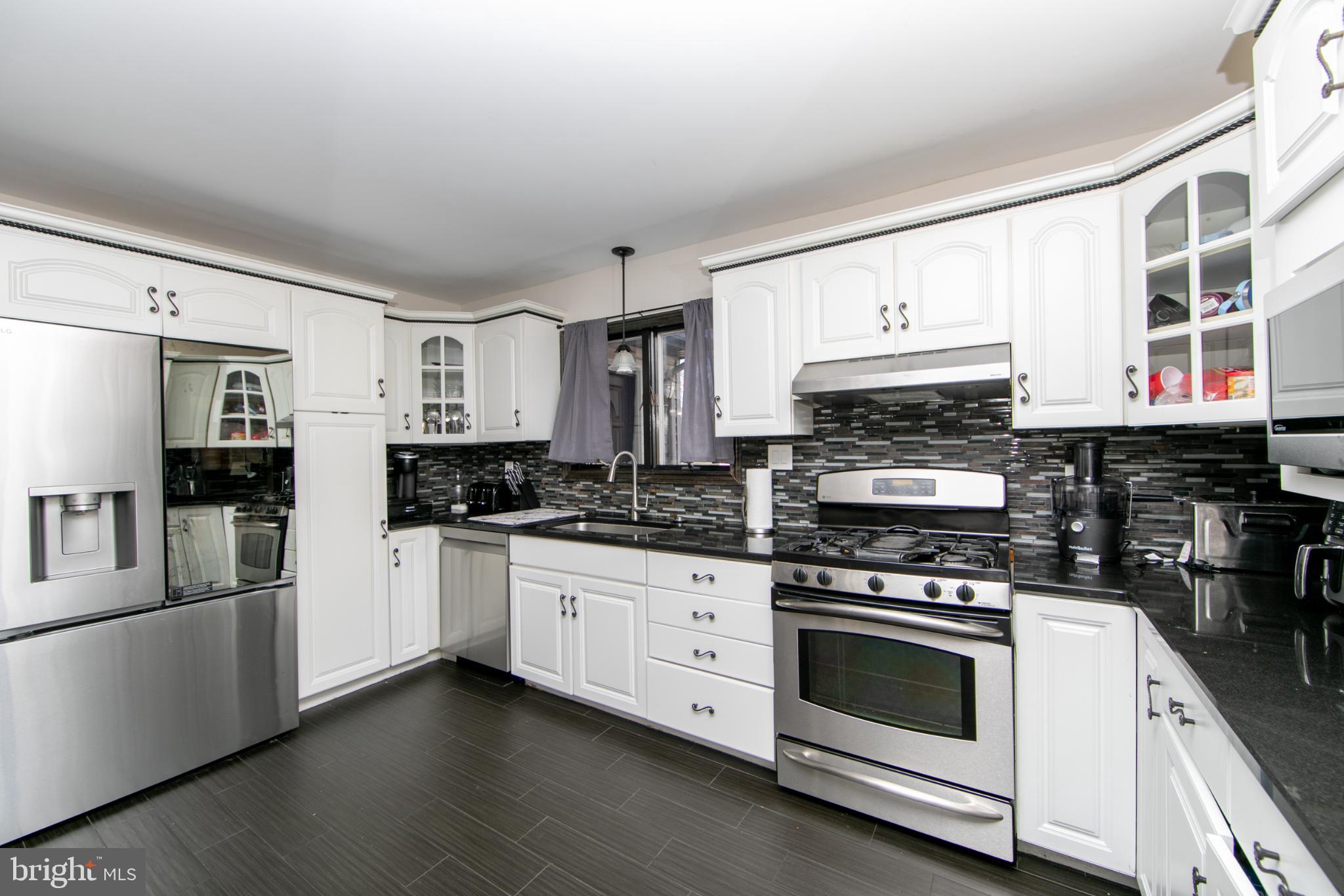 220 Landing Road Blackwood, NJ 08012 - Photo 31 of 63 a kitchen with stainless steel appliances white cabinets and a stove top oven