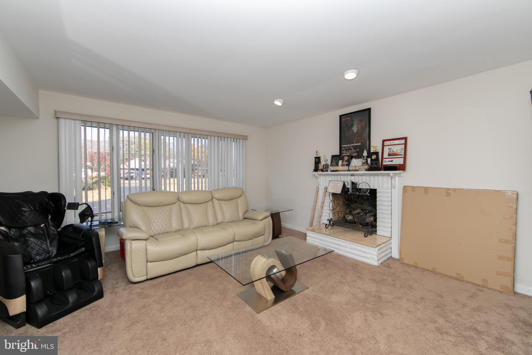 220 Landing Road Blackwood, NJ 08012 - Photo 42 of 63 a living room with furniture a fireplace and a flat screen tv