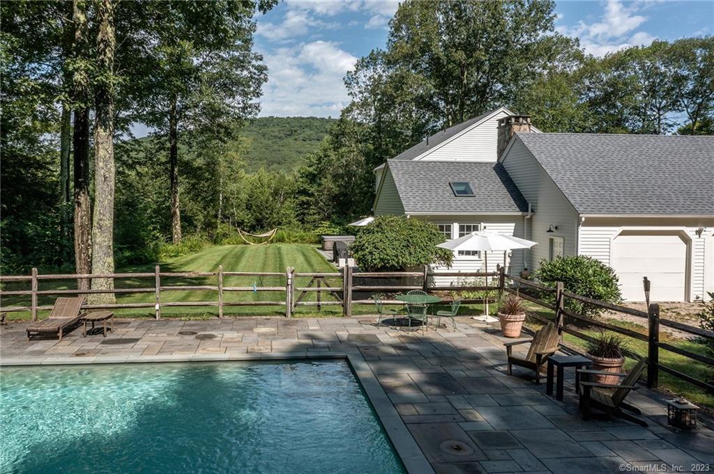 an aerial view of a house with a yard table and chairs
