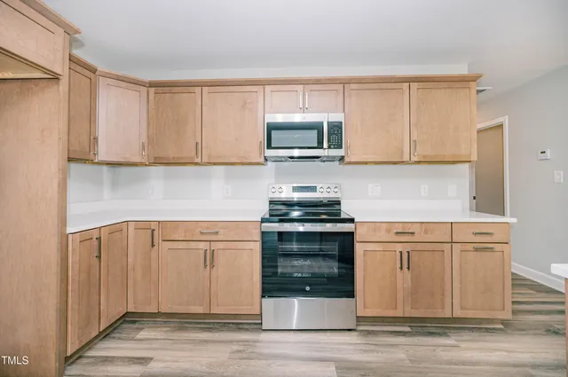 a kitchen with granite countertop a stove and a sink