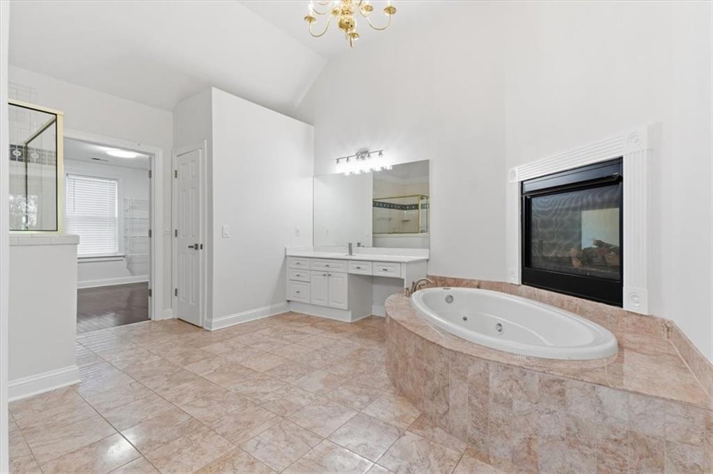 166 Windrift Drive Dallas, GA 30132 - Photo 32 of 72 a bathroom with a tub a double vanity sink a toilet and a mirror