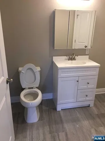 a bathroom with a sink toilet and a mirror