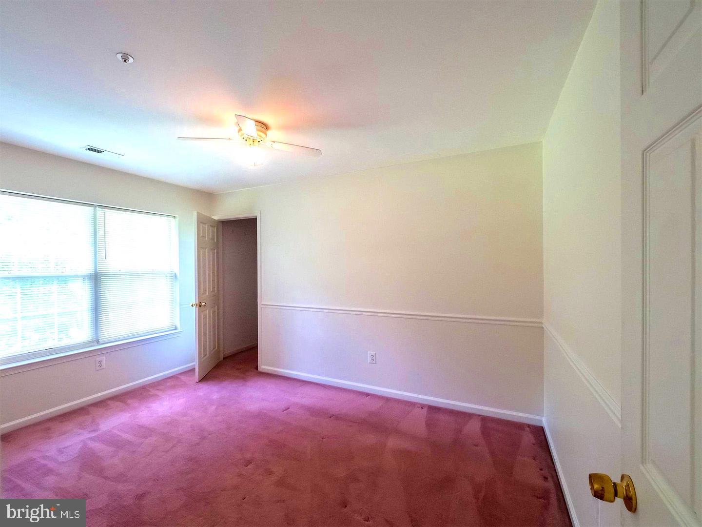 7701 Croom Road Upper Marlboro, MD 20772 - Photo 16 of 46 an empty room with windows and closet