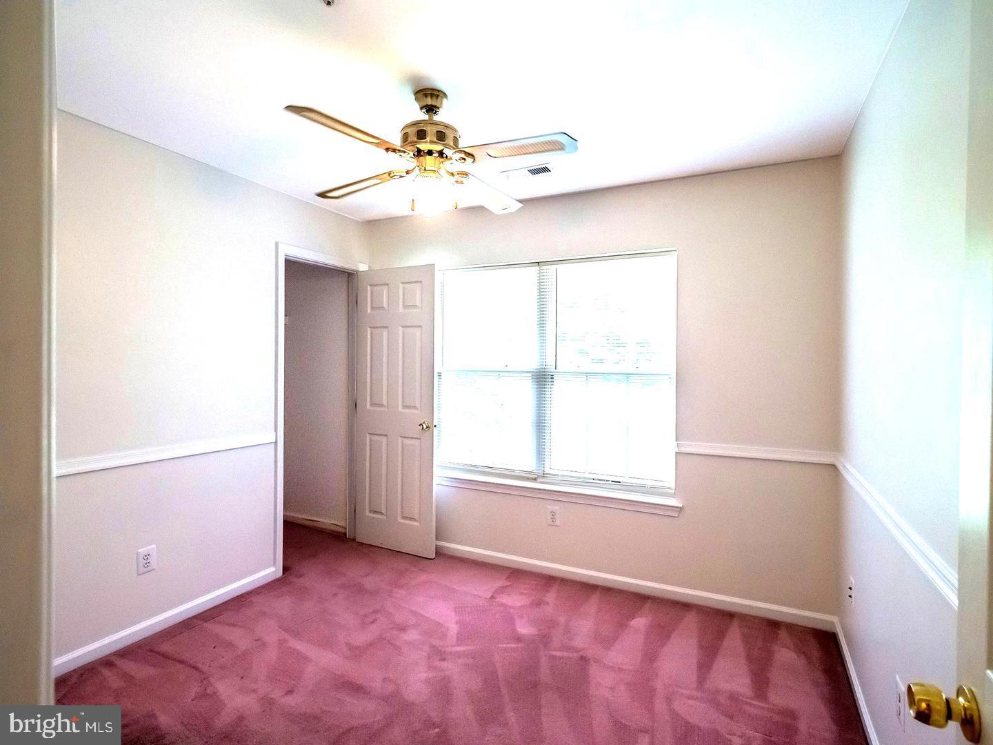 7701 Croom Road Upper Marlboro, MD 20772 - Photo 17 of 46 an empty room with windows and fan