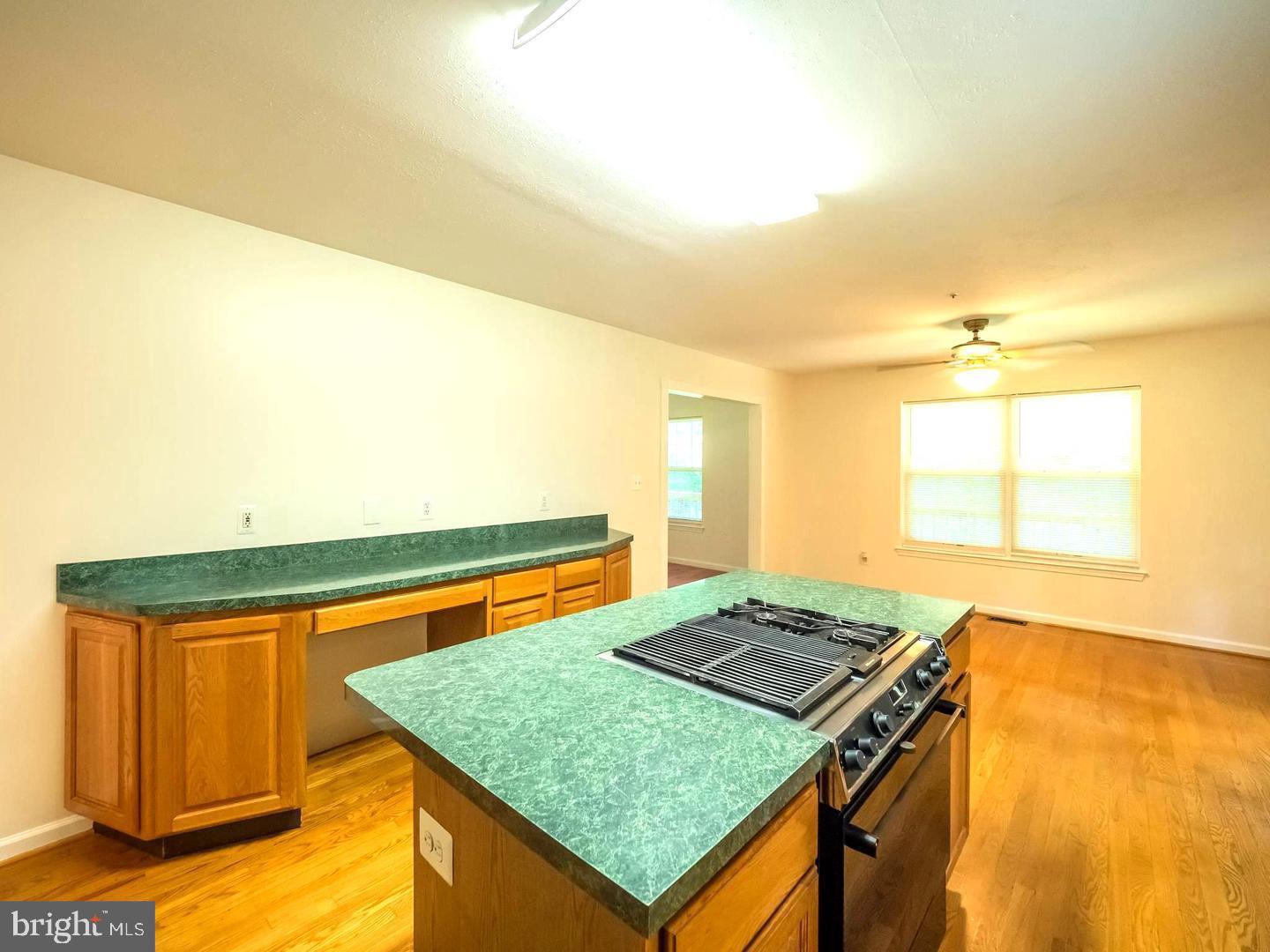 7701 Croom Road Upper Marlboro, MD 20772 - Photo 27 of 46 a kitchen with a sink a counter top space and a window