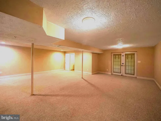 a view of an empty room with closet and window