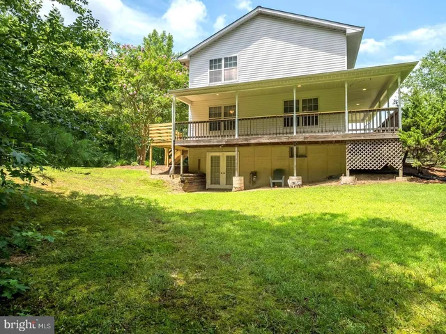 a view of an house with backyard space and balcony