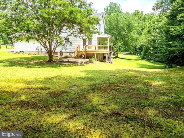 a view of yard with swimming pool and trees