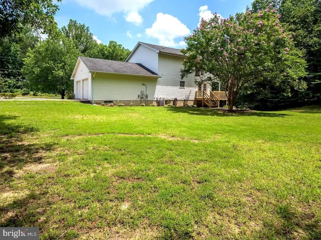 a view of a house with a yard and sitting area