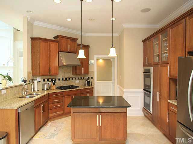 2259 Clayette Court Raleigh, NC 27612 - Photo 9 of 25 Amazing Chef's Kitchen with stainless steel hood over gas cook top, granite countertops, double oven, and beautiful cherry cabinets.Gorgeous tile flooring. Lighting fixtures and recessed lighting. Stainless steel appliances, center island, storage space. Kitchen