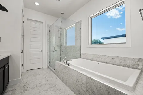 a spacious bathroom with a tub and shower