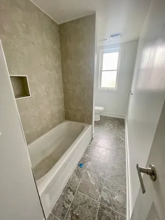 a bathroom with a bathtub and a shower