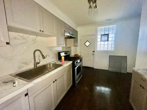 a kitchen with a sink and cabinets