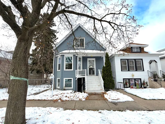 a view of a house with snow on the tree