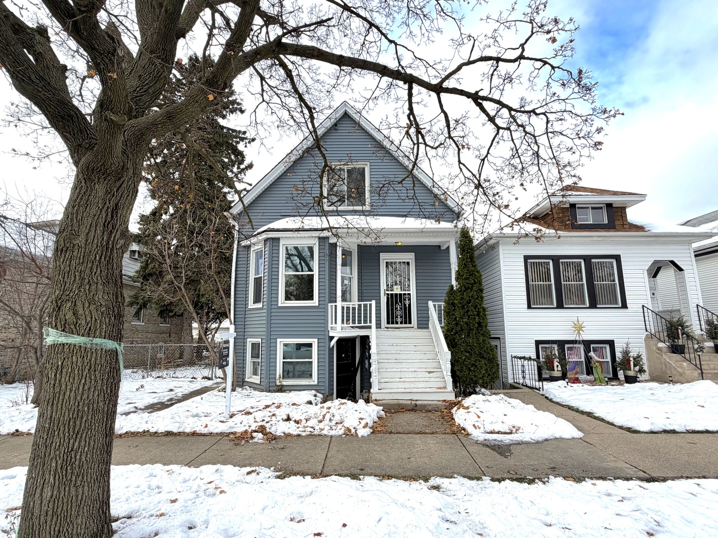 a view of a house with snow on the tree