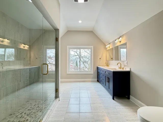 a bathroom with a sink a toilet and mirror