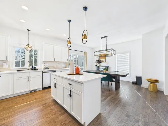 a kitchen with stove and white cabinets