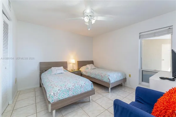 a bedroom with two beds and a couch