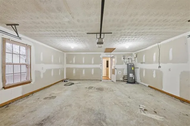 a view of a room with a ceiling fan and a window