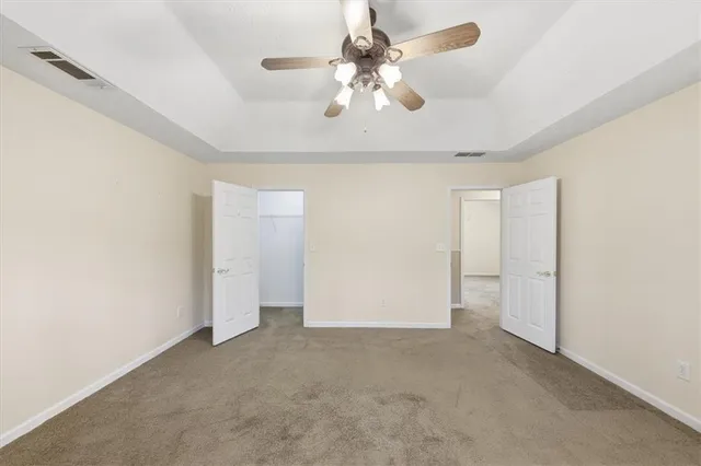 a bathroom with a granite countertop sink a toilet and mirror