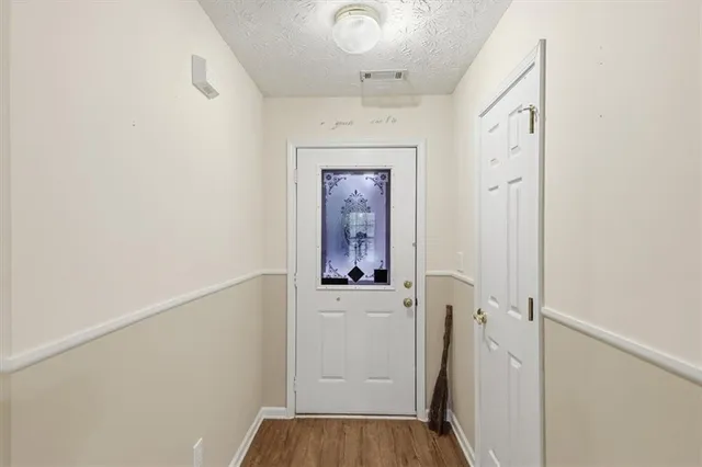 a view of an empty room with window and fireplace