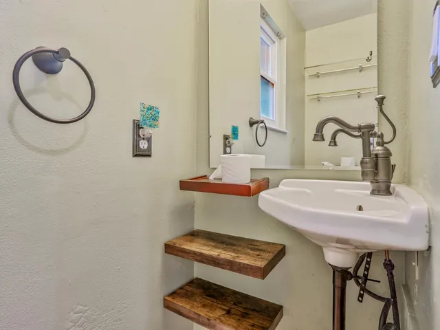a view of staircase with wooden floor and white walls