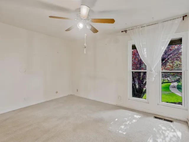 a view of an empty room with a window