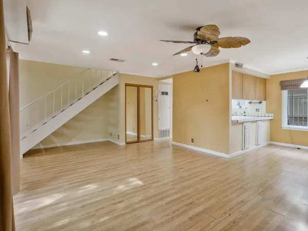 a view of a room with wooden floor and window