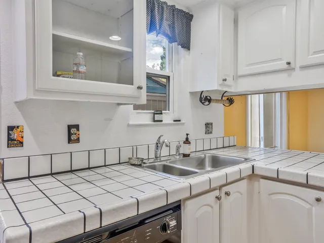 a stove top oven sitting inside of a kitchen