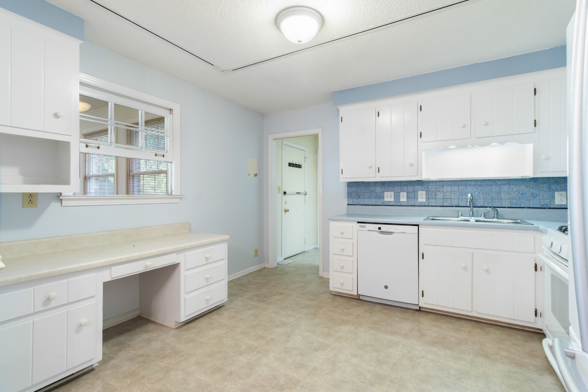307 Revere Road Clarksville, TN 37043 - Photo 15 of 38 a kitchen with cabinets appliances a sink and a window
