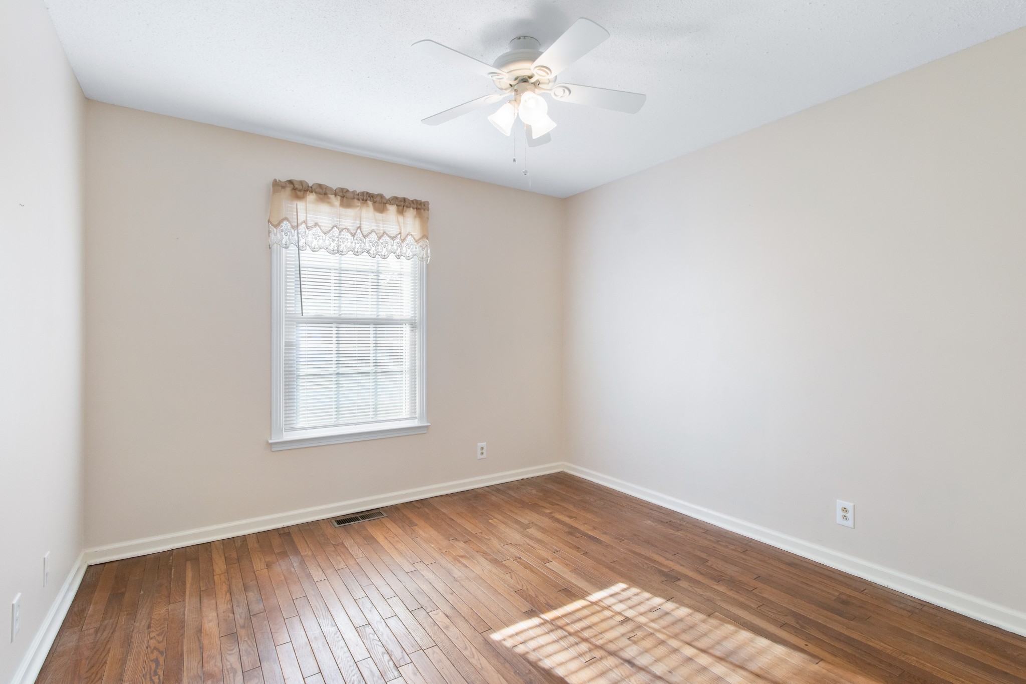 307 Revere Road Clarksville, TN 37043 - Photo 27 of 38 an empty room with a window and wooden floor