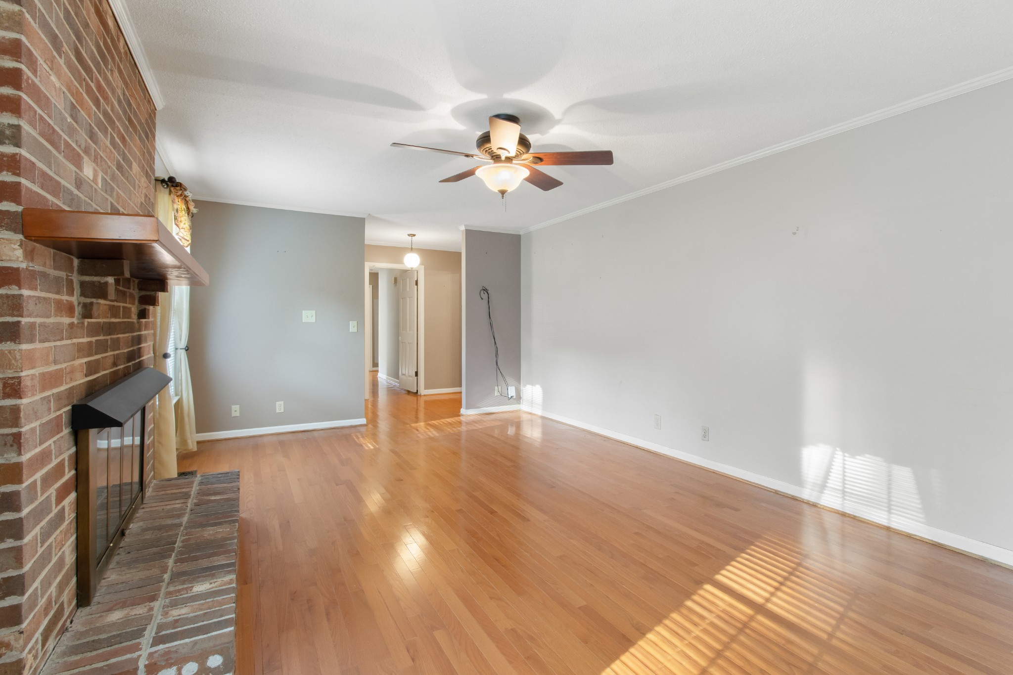 307 Revere Road Clarksville, TN 37043 - Photo 9 of 38 wooden floor in an empty room with a fireplace